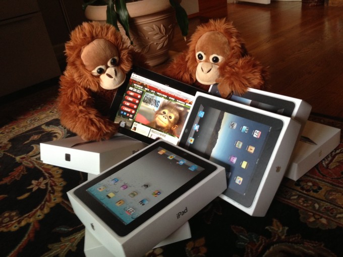 Orangutan Outreach interns inspecting iPads donated by NatGeo.