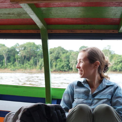 Andrea Knox seated on a river boat in Indonesia, supporting the Orangutan Outreach mission as Senior Program Manager